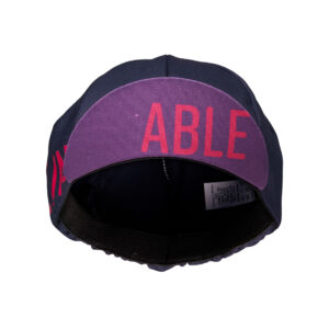The Grape Royale Cap features a classic design, short shade, and elastic fit in the color grape.