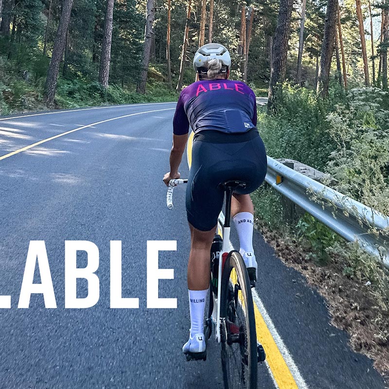 Photo of Anna Katrine riding her bike. The words ABLE is written on the image.