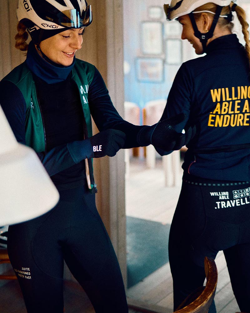 Two women from WeCycling standing together and wearing Willing Able apparel.