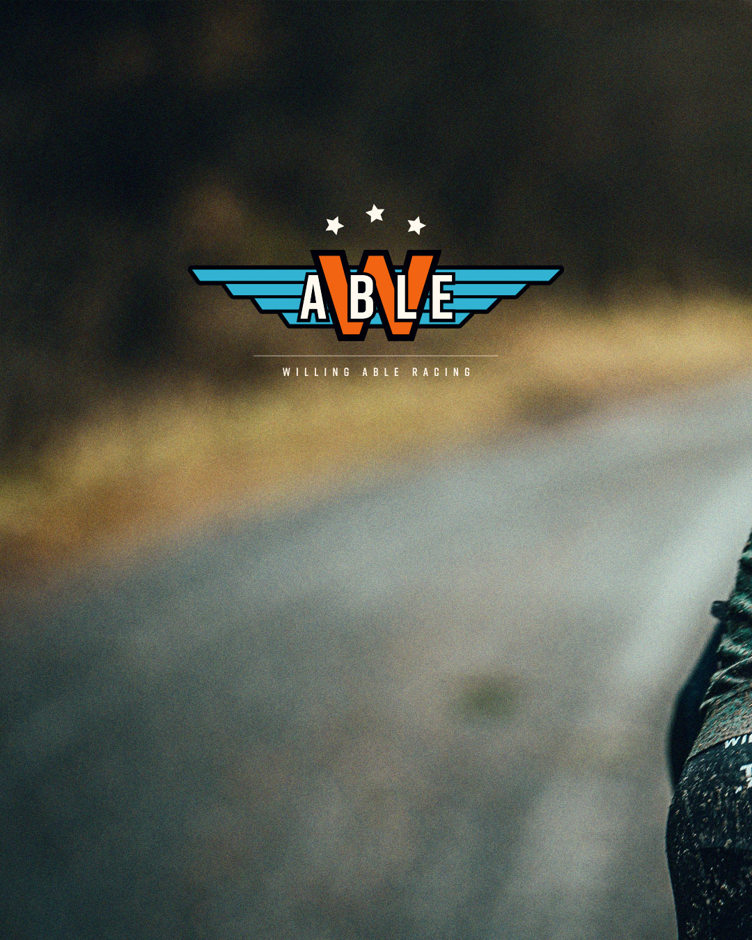 A blurred road photo with the logo of Willing Able at the front.