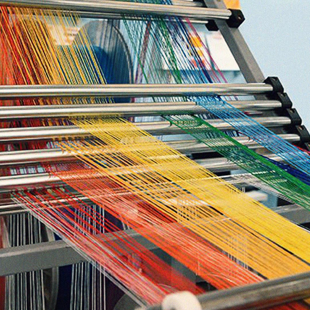 Yarn in different colors on a textile machine.