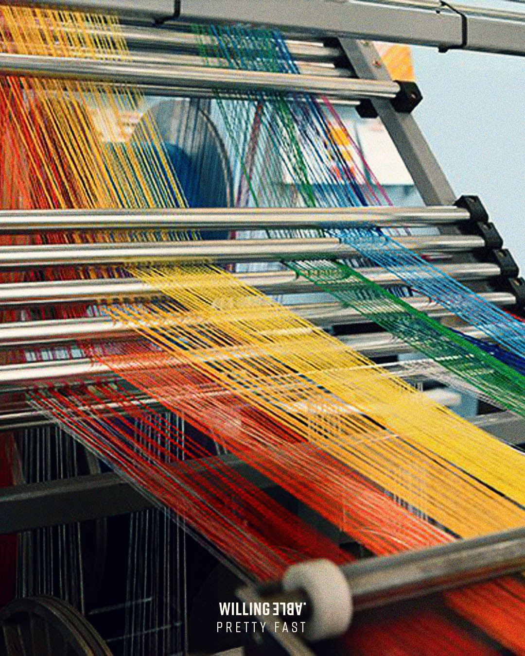Yarn in different colors on a textile machine.