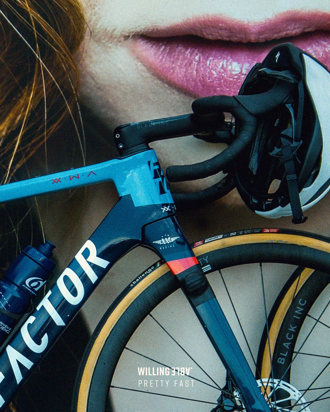 Picture of a bike in front of a big poster of a woman.