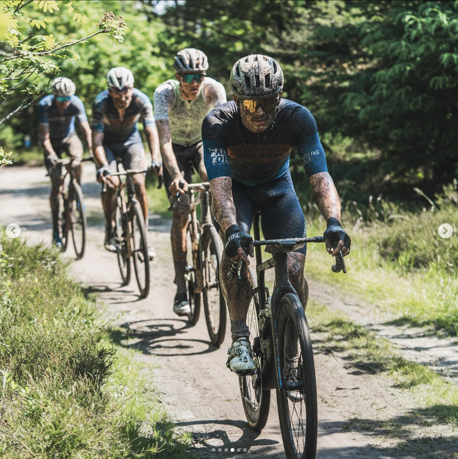 Cyclists from WIlling Able riding on a dirt road in the Blaavand Gravel race.