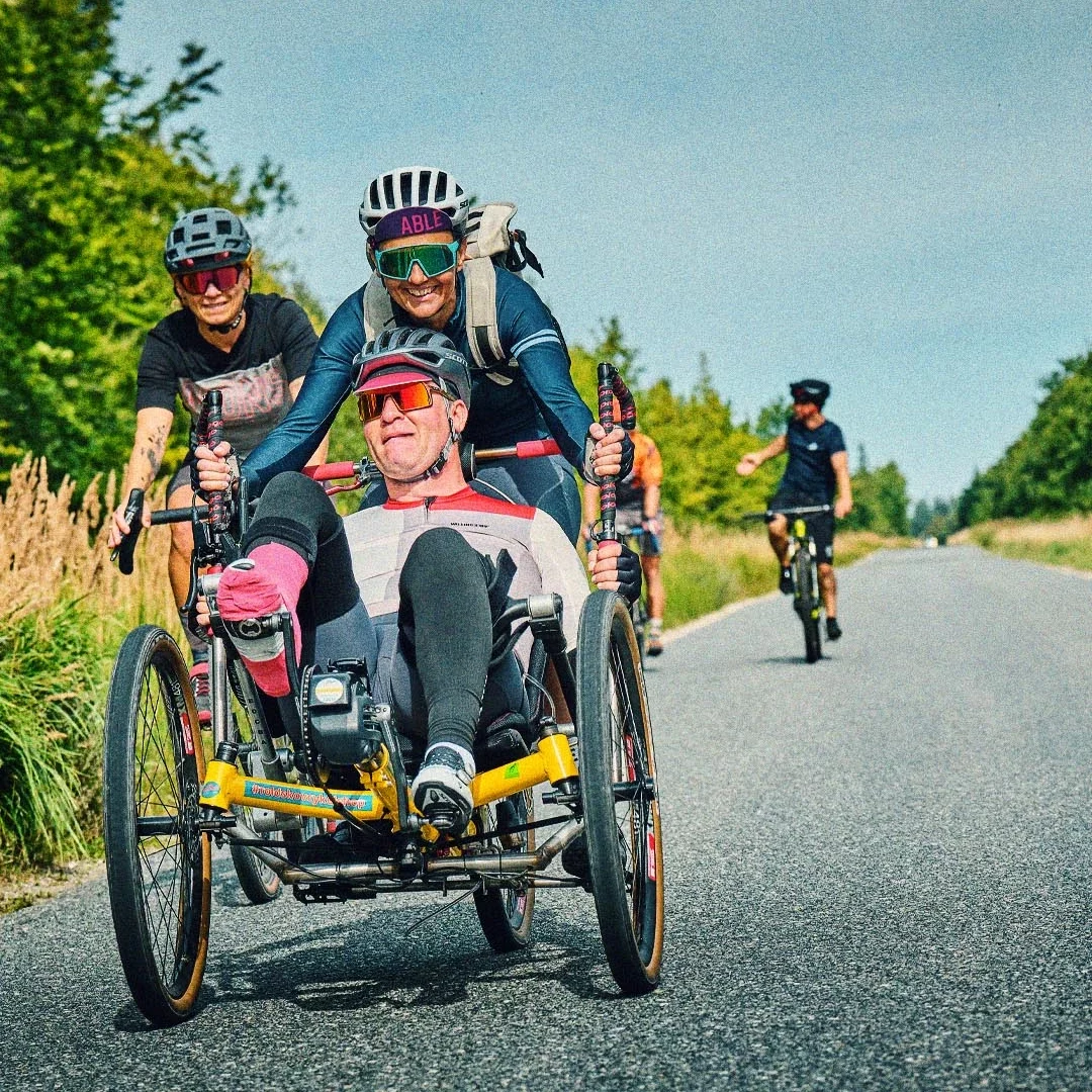 Michael Dvinge cycling on his three-wheeled recumbent bike during Tour de Jutland, inspiring people with and without disabilities.