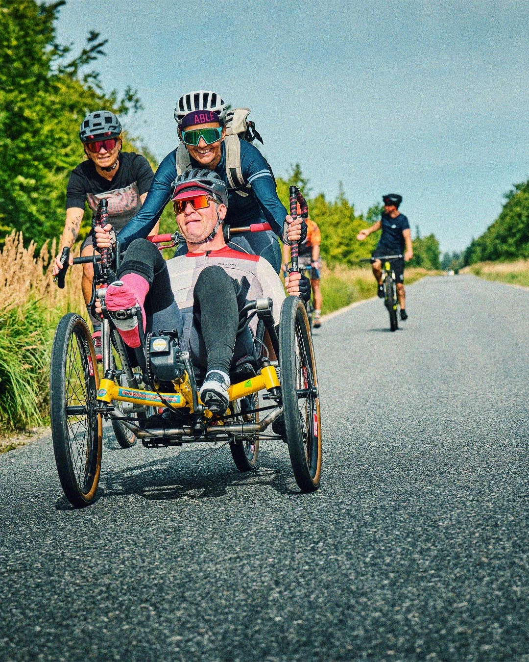 Michael Dvinge cycling on his three-wheeled recumbent bike during Tour de Jutland, inspiring people with and without disabilities.